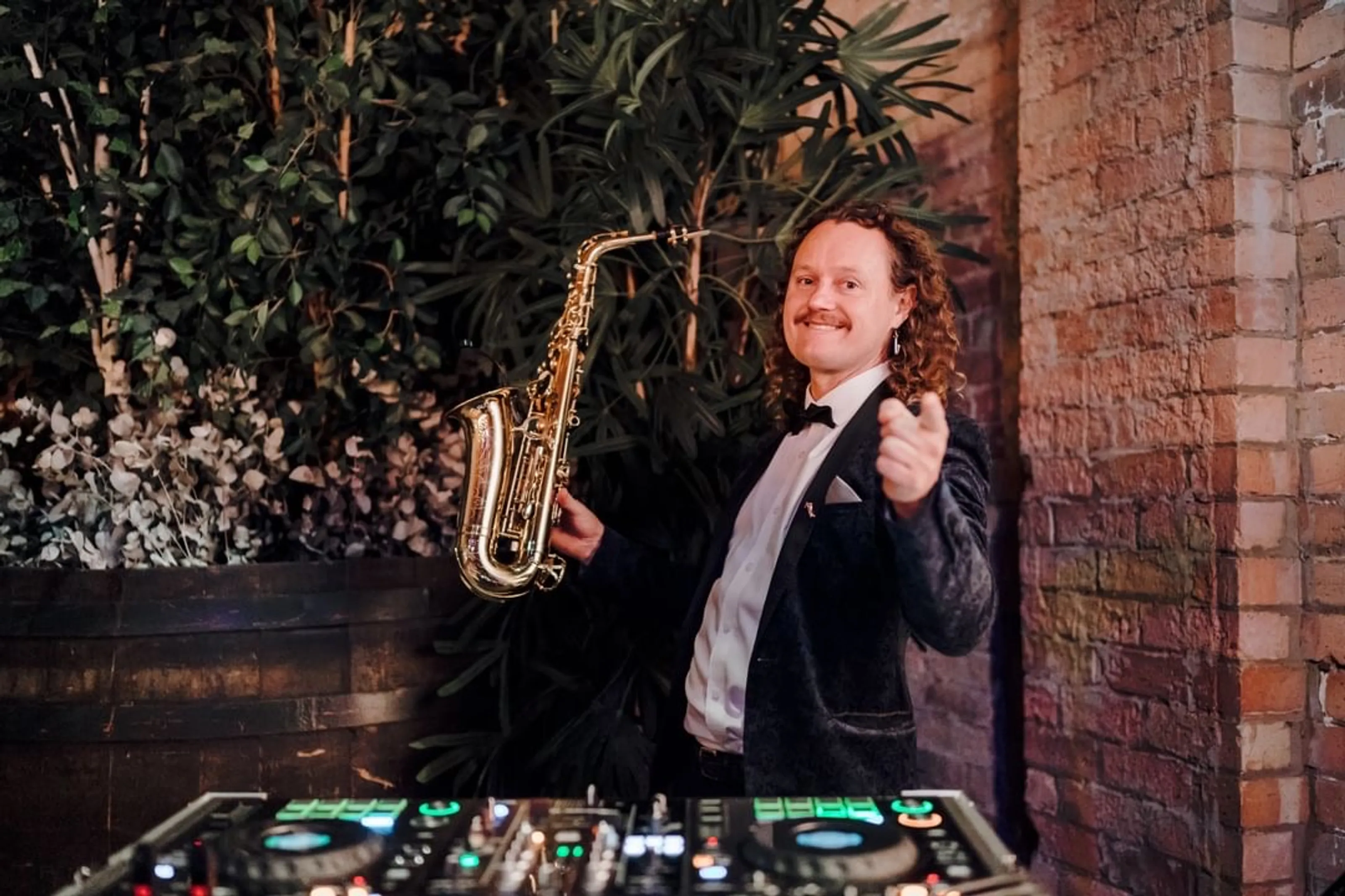 Ian performing saxophone at a wedding reception
